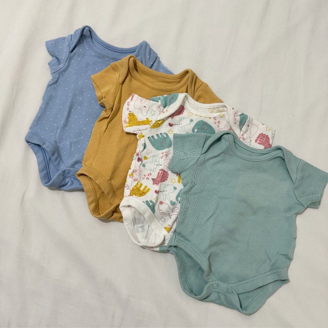 Mothercare Newborn Bodysuits - 4 Pieces (Category: Babies & Kids Fashion) located in Pasig City. Submitted by speciallyselected (Listing ID 1407585973, Image 1). Description: - Set of 4 short-sleeved baby bodysuits - Includes: - Blue polka dot bodysuit - Mustard yellow bodysuit - Patterned bodysuit - Teal bodysuit (labeled "new baby up to 7.5lbs / 3.4kg") - Made of 100% cotton - Perfect for newborns.