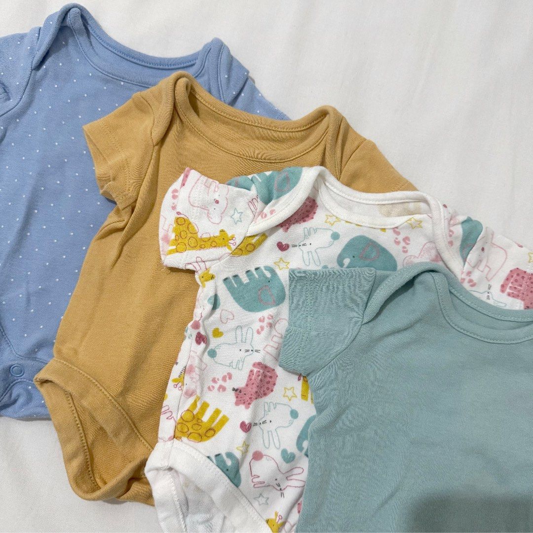 Mothercare Newborn Bodysuits - 4 Pieces (Category: Babies & Kids Fashion) located in Pasig City. Submitted by speciallyselected (Listing ID 1407585973, Image 2). Description: - Set of 4 short-sleeved baby bodysuits - Includes: - Blue polka dot bodysuit - Mustard yellow bodysuit - Patterned bodysuit - Teal bodysuit (labeled "new baby up to 7.5lbs / 3.4kg") - Made of 100% cotton - Perfect for newborns.