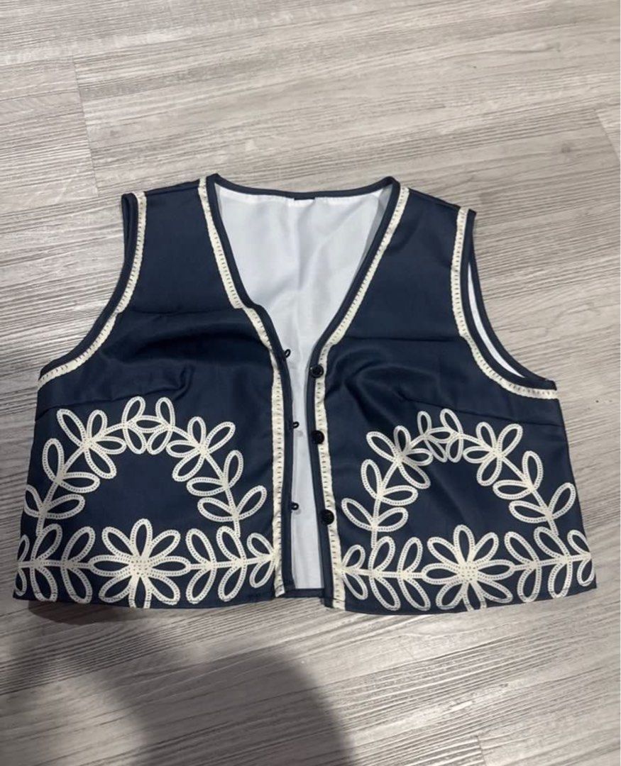 Navy Blue Floral Embroidered Vest Top (Category: Sleeveless) located in San Juan City. Submitted by kassyjsn (Listing ID 1407714191, Image 3). Description: Classy top! Size S but fits M also. Used only for 2 hours :) Shoulder: 14in Length: 15in Bust: 37in - Navy blue vest - White floral embroidery - V-neck design - Button-down closure - White lining and trim - Great for layering - Chic and stylish.