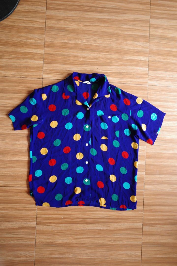 Polka Dot Button-Up Shirt (Category: Shirts) located in Makati City. Submitted by bluelocker (Listing ID 1407652717, Image 1). Description: - Blue button-up shirt - Features colorful polka dots - Short sleeves - Chest pocket - Classic collar - Button-down front - Lightweight fabric - Ideal for warm weather.