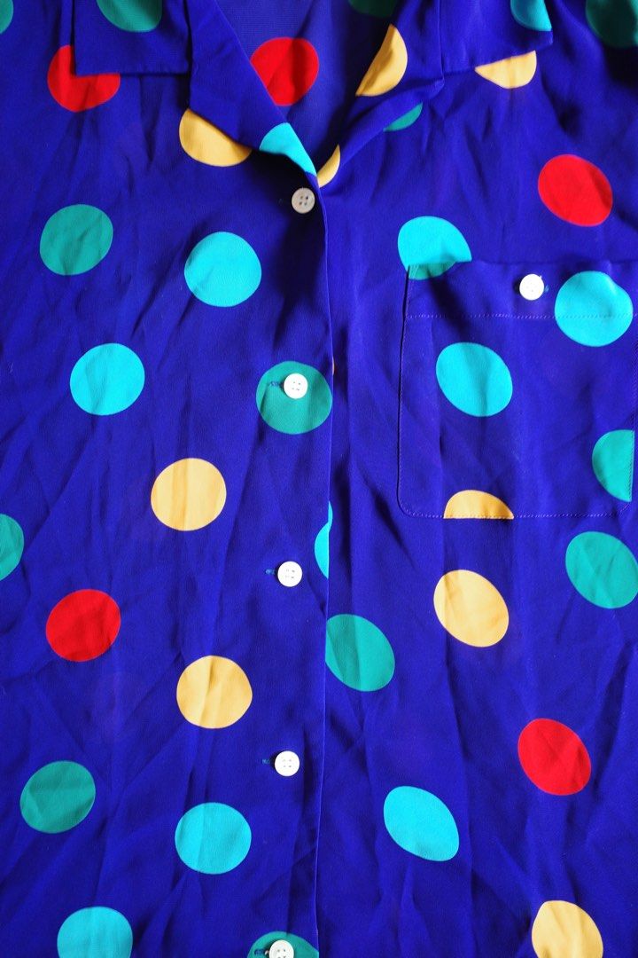 Polka Dot Button-Up Shirt (Category: Shirts) located in Makati City. Submitted by bluelocker (Listing ID 1407652717, Image 2). Description: - Blue button-up shirt - Features colorful polka dots - Short sleeves - Chest pocket - Classic collar - Button-down front - Lightweight fabric - Ideal for warm weather.