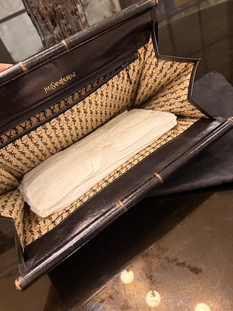Saint Laurent Black Clutch Bag (Category: Luxury Bags & Wallets) located in Cavite. Submitted by kleaningoutmykloset (Listing ID 1407646750, Image 3). Description: - Saint Laurent clutch bag - Chevron-quilted design - Flap closure with YSL logo - Includes dust bag - Interior lining with repeating YSL logo pattern.