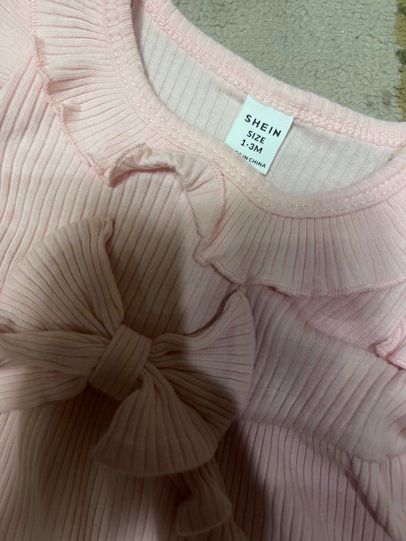 SHEIN Pink Ruffle Dress 1-3M (Category: Dresses) located in Manila. Submitted by pretty_perrydecluttery (Listing ID 1407667803, Image 3). Description: - Pink SHEIN baby dress - Designed for 1-3 month olds - Features ribbed texture - Ruffled sleeves and neckline - Cute bow detail - Flared skirt - Comfortable fit - Ideal for special occasions or everyday wear.