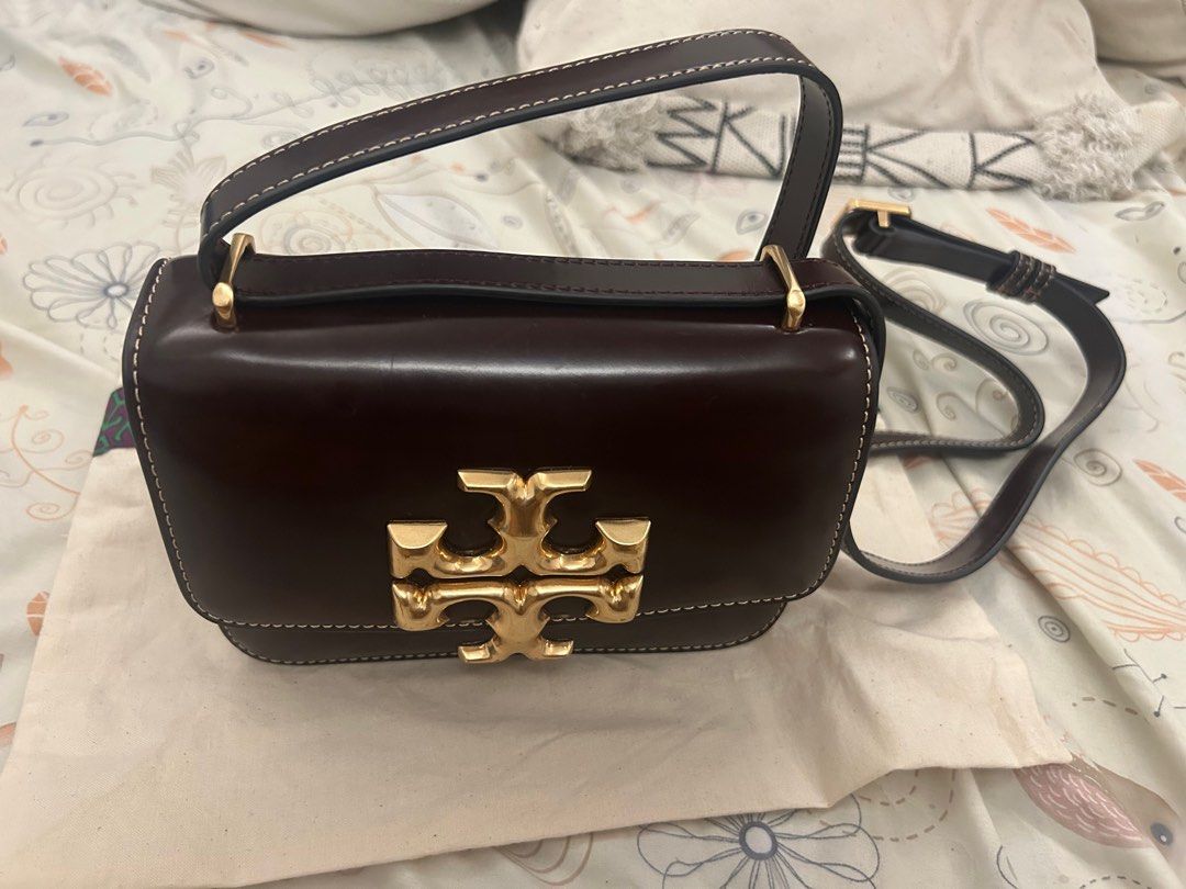 Tory Burch Brown Leather Crossbody Bag (Category: Luxury Bags & Wallets) located in Cavite. Submitted by baglover26 (Listing ID 1407642576, Image 2). Description: - Tory Burch crossbody bag - Rich brownish red leather - Gold-tone logo and buckle - Includes dust bag - Structured design with white stitching - Adjustable long strap for shoulder or crossbody wear.