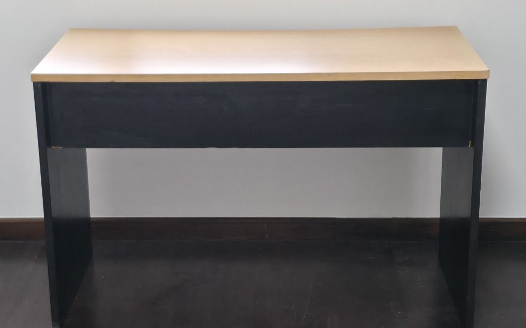 Tidy Study Table (Category: Tables & Sets) located in Singapore. Submitted by coolseabreeze (Listing ID 1407755597, Image 3). Description: - Black frame with light wood-colored tabletop - Sturdy and ready for immediate use - Perfect for students or compact workspaces - Simple and functional design - Dimensions (approx) : 110cm x 50cm 75cm .