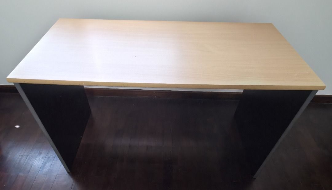 Tidy Study Table (Category: Tables & Sets) located in Singapore. Submitted by coolseabreeze (Listing ID 1407755597, Image 2). Description: - Black frame with light wood-colored tabletop - Sturdy and ready for immediate use - Perfect for students or compact workspaces - Simple and functional design - Dimensions (approx) : 110cm x 50cm 75cm .