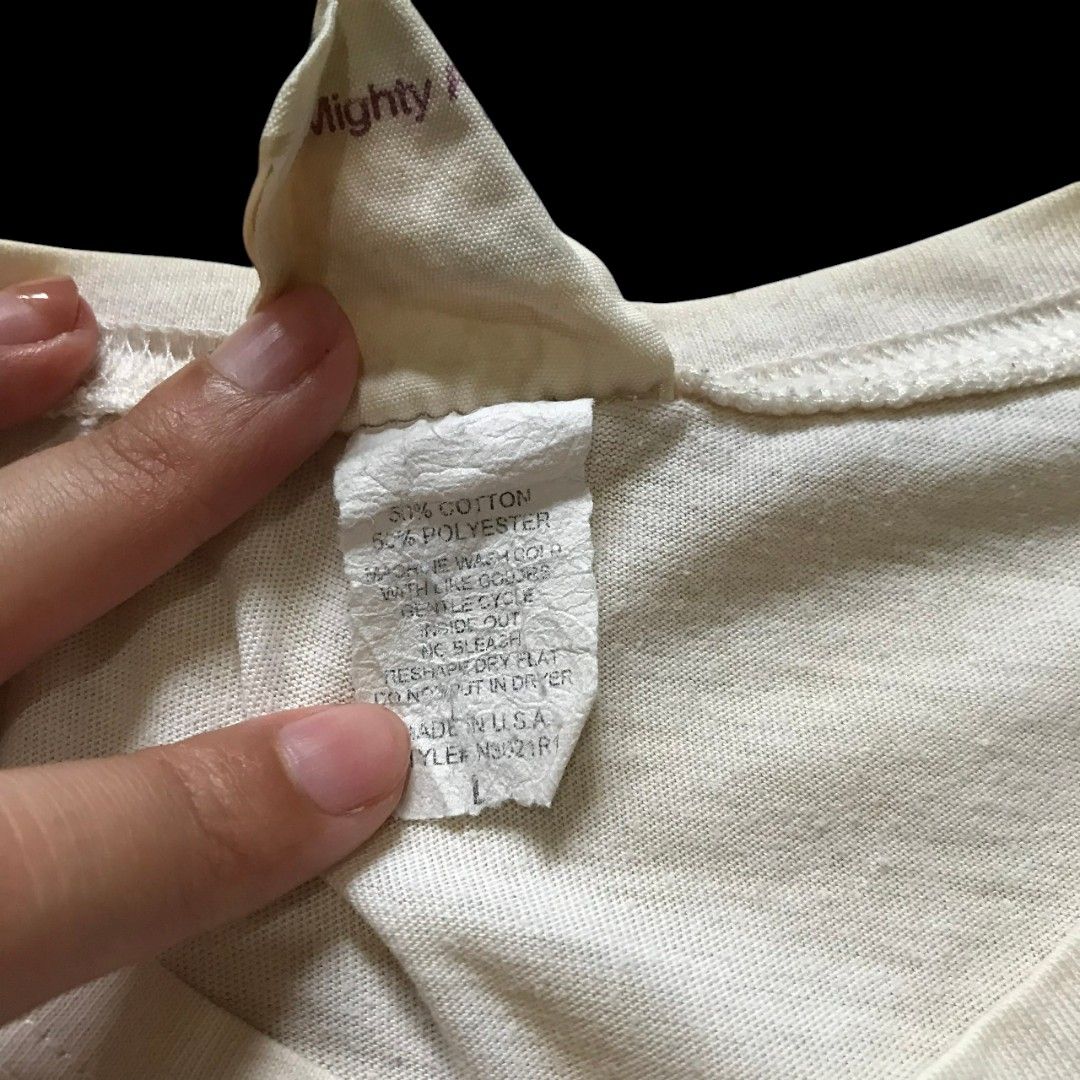 Y2K Graphic Statement Baby Tee| 90s vintage (Category: Shirts) located in Taguig. Submitted by decl999tter (Listing ID 1407628941, Image 3). Description: - Cream-colored t-shirt - Brand: Mighty Fine (Made in USA) - Size: S-L - Material: 50% Cotton, 50% Polyester - Style: Crew neck, short sleeves.