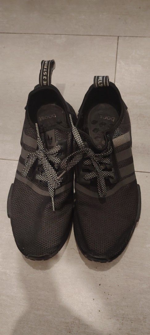 Size 9. 5 Adidas NMD r1 (Category: Sneakers) located in Pasay City. Submitted by dollph (Listing ID 1412618324, Image 3). Description: Adidas NMD sneakers in black. Features the iconic three stripes on the side and the Adidas logo on the tongue. The shoes have a mesh upper and a boost sole. The laces are grey and white. The heel tab has the Adidas branding..