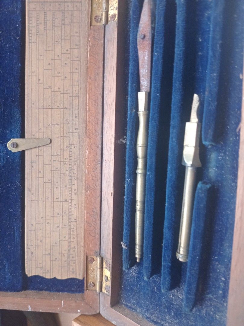 Antique 1880 technical drawing instrument Slide Rule and Tool Set (Category: Stationery & School Supplies) located in Manila. Submitted by padillahe35291 (Listing ID 1412568901, Image 1). Description: - Antique tool set - Includes slide rule and two brass tools - Housed in a wooden box with blue velvet interior - Box features brass hinges - Great for collectors of vintage tools.