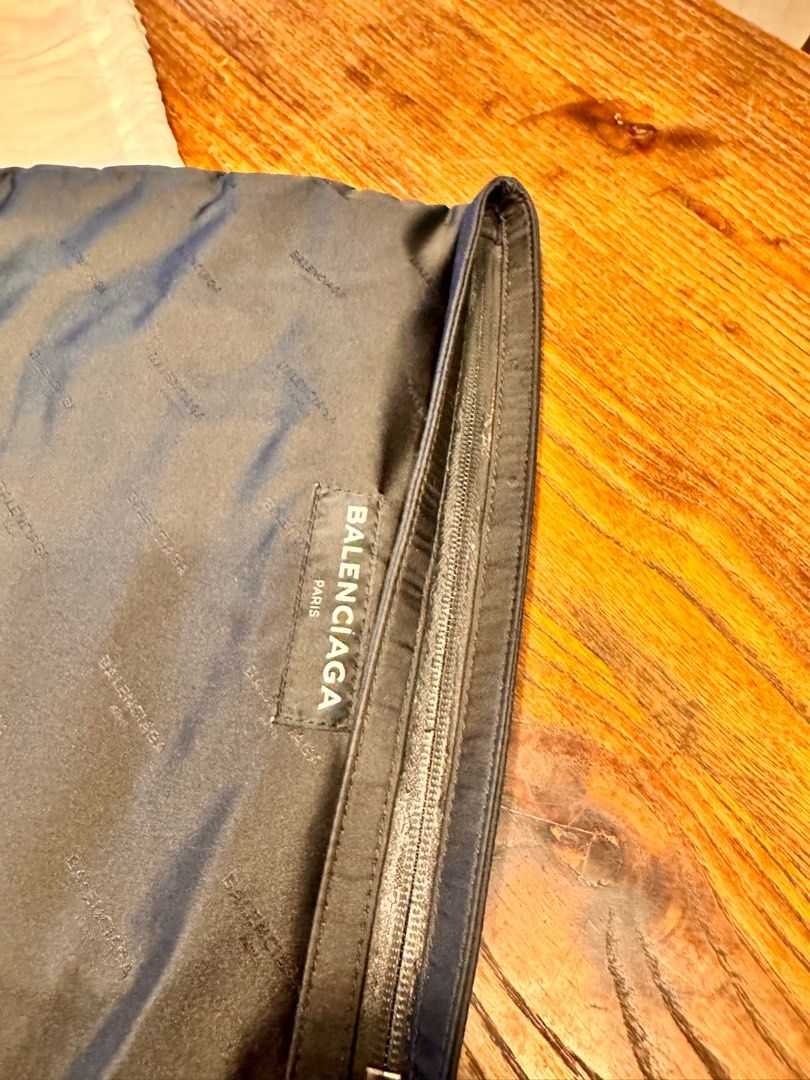Balenciaga Paris Clutch (Category: Luxury Bags & Wallets) located in Taguig. Submitted by pritsu (Listing ID 1412550529, Image 2). Description: Decluttering personal items. Bought in Greenbelt. PM for more photos. - Balenciaga Paris clutch - Black exterior with Balenciaga logo - Zipper closure - Includes a small Balenciaga label - Comes with a dust bag.