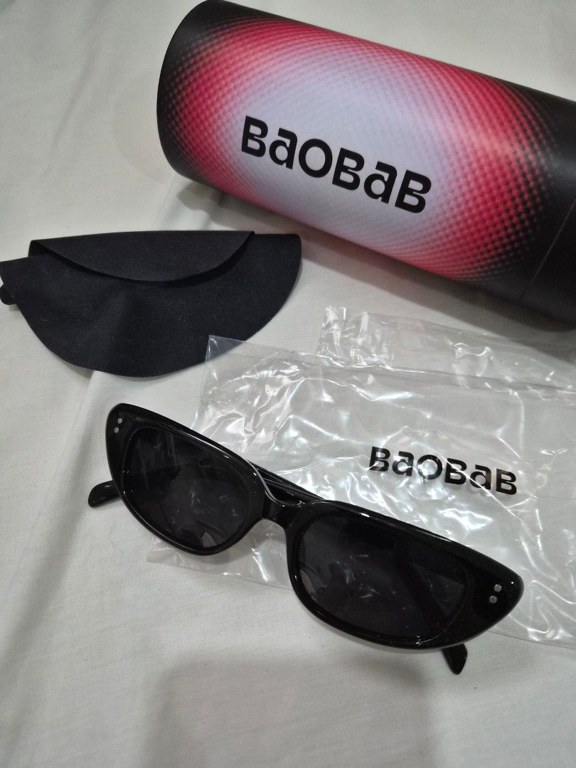 Baobab Sunglasses retro cateye (Category: Sunglasses & Eyewear) located in Quezon City. Submitted by mooneon (Listing ID 1412611583, Image 1). Description: - Baobab sunglasses - Sleek black frame - Dark lenses - Includes protective case - Comes with cleaning cloth - Branded carrying tube - Modern design - Perfect for everyday wear - Baobab logo visible.