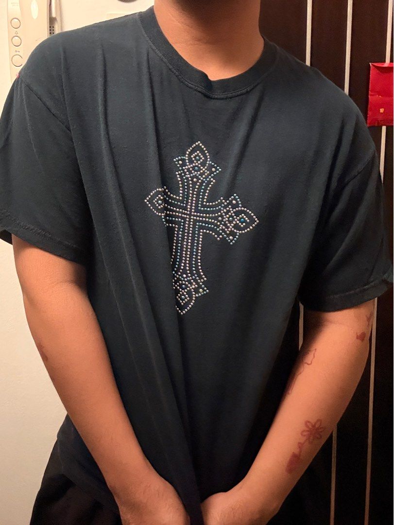 Black Cross Rhinestone T-shirt (Category: Tshirts & Polo Shirts ) located in Mandaluyong City. Submitted by thetinycloset_ (Listing ID 1412694499, Image 1). Description: - Black t-shirt - Rhinestone cross design on front - Embellished with various rhinestone sizes - Short sleeves - Crew neck - Standard cotton blend fabric - Dark color (black or very dark navy).