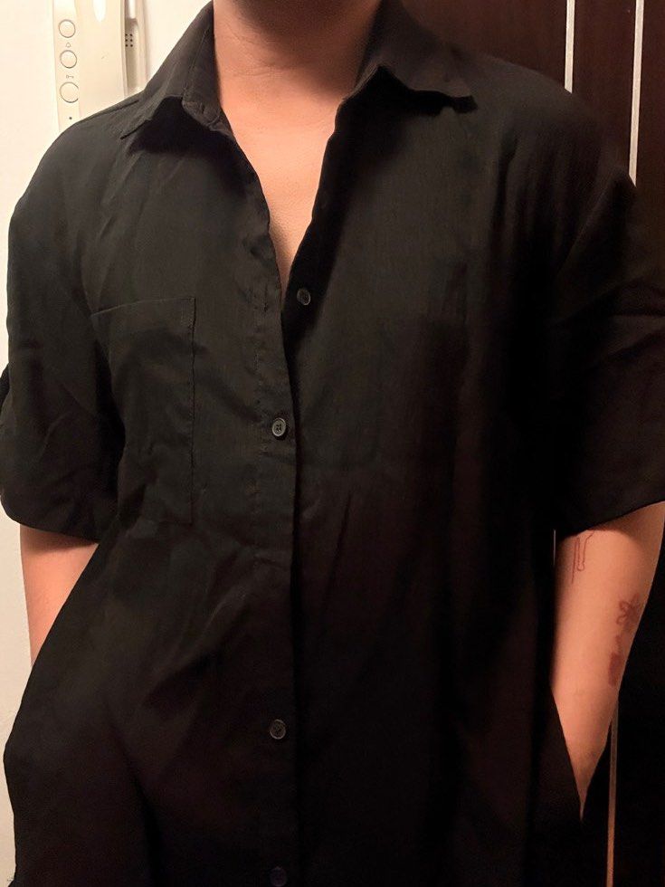 Black Short Sleeve Shirt (Category: Shirts) located in Mandaluyong City. Submitted by thetinycloset_ (Listing ID 1412695307, Image 1). Description: - Black short sleeve shirt - Collared neckline - Button-down closure - Roll-up sleeves with button closure - Single chest pocket - Lightweight fabric - Missing button.