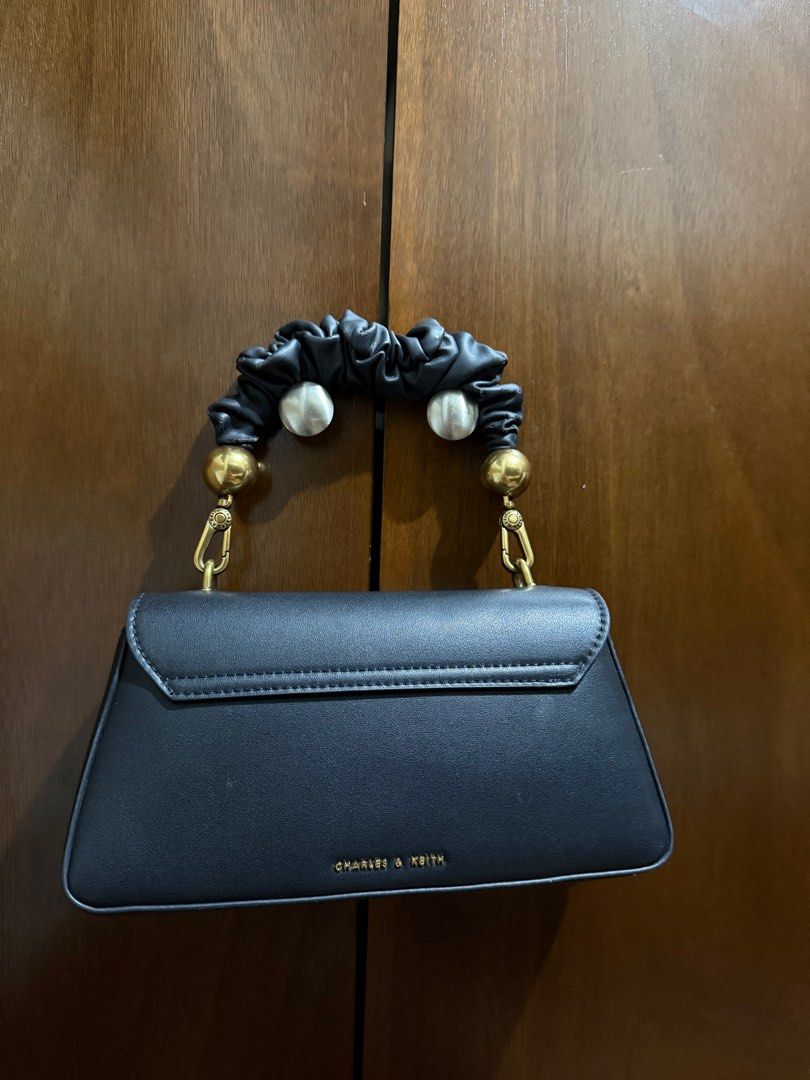 Charles & Keith Scrunchie Handle Bag (Category: Shoulder Bags) located in Manila. Submitted by threshold01 (Listing ID 1412659234, Image 2). Description: - Nagbabakbak yung handle, up close noticeable but not if malayuan (please see pics) - No strap - Charles and Keith bag - No box .