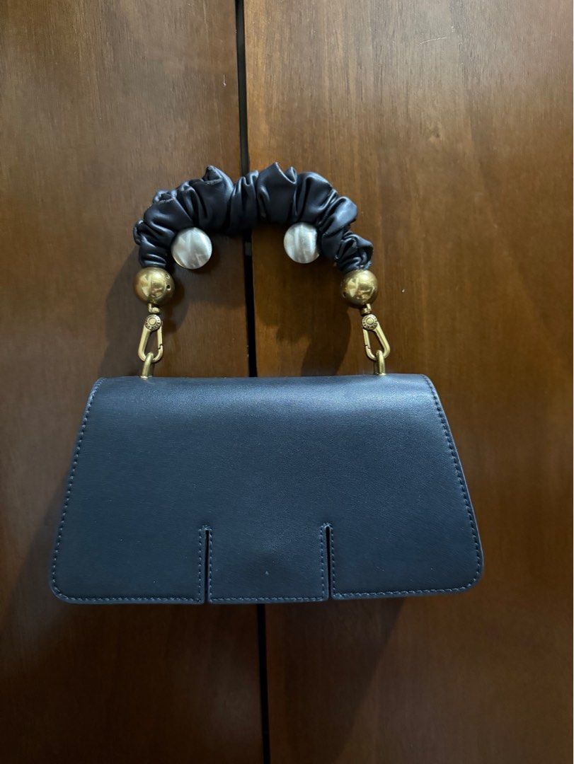 Charles & Keith Scrunchie Handle Bag (Category: Shoulder Bags) located in Manila. Submitted by threshold01 (Listing ID 1412659234, Image 1). Description: - Nagbabakbak yung handle, up close noticeable but not if malayuan (please see pics) - No strap - Charles and Keith bag - No box .