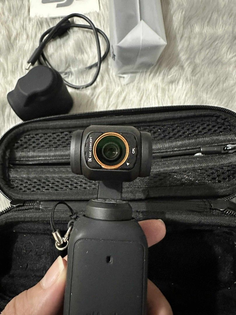 DJI OSMO Pocket 3 Camera (Category: Cameras) located in Makati City. Submitted by erjan.malimban-50624 (Listing ID 1412673280, Image 2). Description: - DJI OSMO Pocket 3 camera - Includes: carrying case, charging cable, lens cover, tripod and small pouch -silicone case and hard case included - very protected.