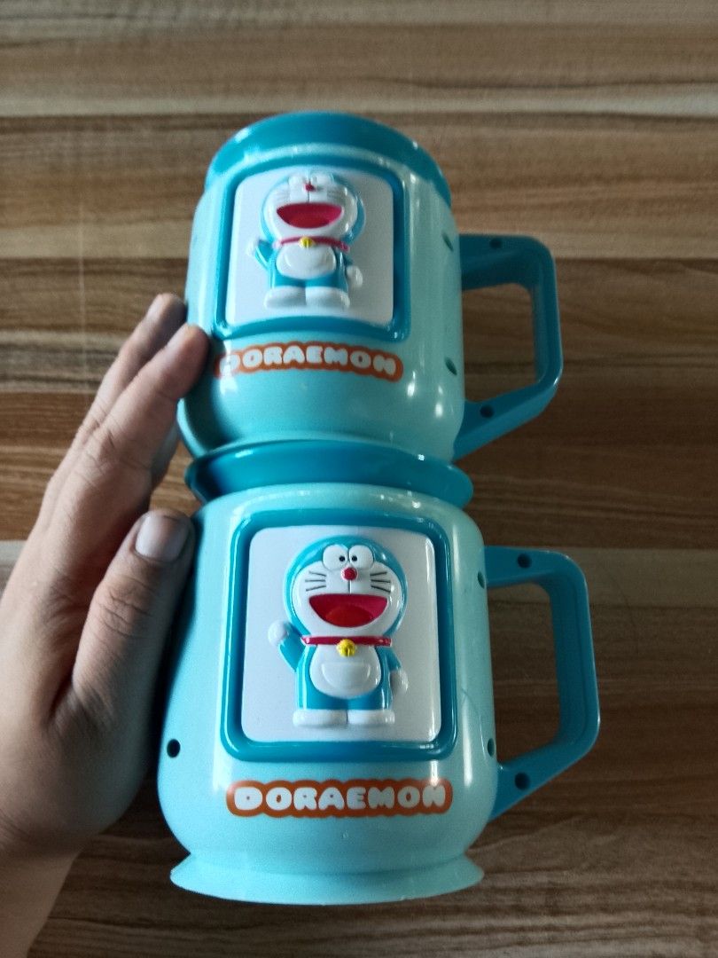 Doraemon Mugs (Category: Coffee & Tea Tableware) located in Davao. Submitted by Ysang40 (Listing ID 1412698811, Image 2). Description: 150 each, as is ito, ang isa walang takip sa bottom, same price.