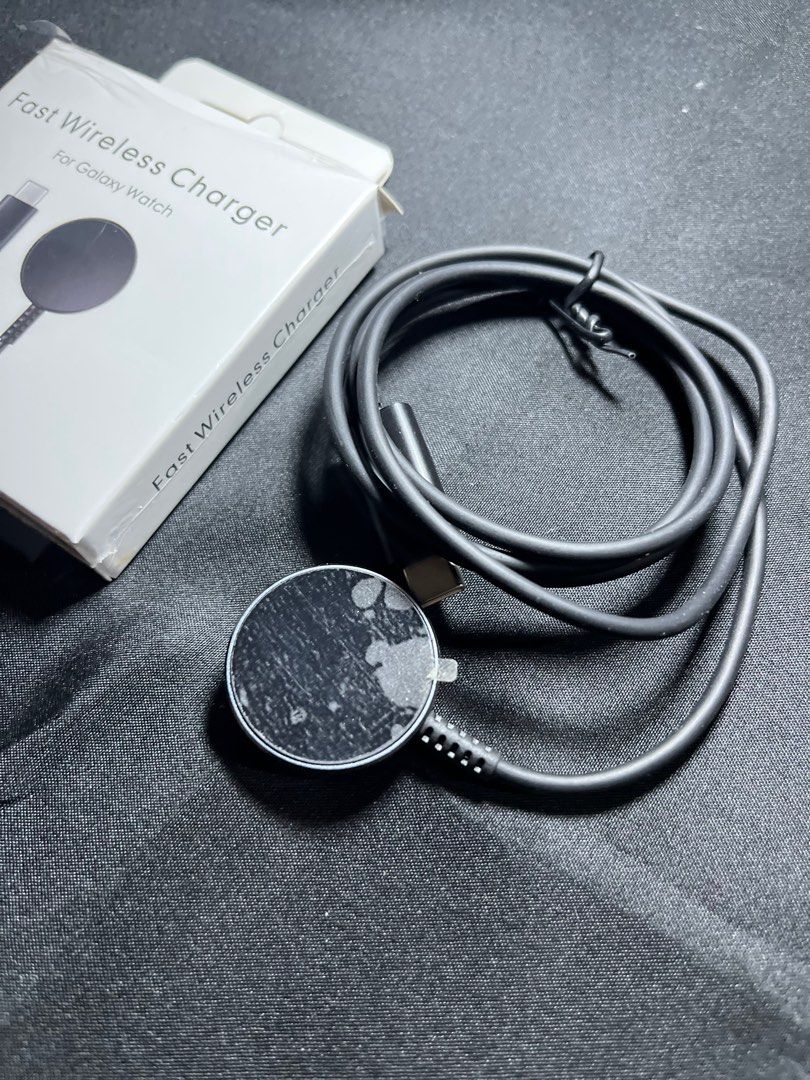 Fast Wireless Charger for Galaxy Watch (Category: Chargers & Cables) located in Manila. Submitted by nhh_accessories (Listing ID 1412691037, Image 2). Description: - Fast wireless charger for Galaxy Watch - Includes charging cable - Compatible with Galaxy Watch - Comes with the original box - Black color and round charging pad.