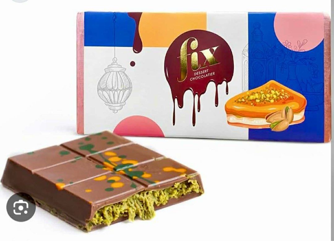 Fix Dessert Chocolatier Pistachio Chocolate Bar (Category: Other Food & Drinks) located in Manila. Submitted by mayeli (Listing ID 1412694852, Image 3). Description: Indulge in a delicious Fix Dessert Chocolatier chocolate bar. This bar features a rich chocolate exterior with a pistachio filling. The packaging showcases the brand's logo and a picture of the chocolate bar. Several bars are available, perfect for gifting or personal enjoyment..