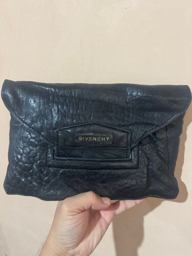 Givenchy Black Leather Clutch (Category: Luxury Bags & Wallets) located in Lingayen. Submitted by lux_thrift (Listing ID 1412529690, Image 1). Description: approximately 11 x 7 inches soft leather has some press marks needs shine .