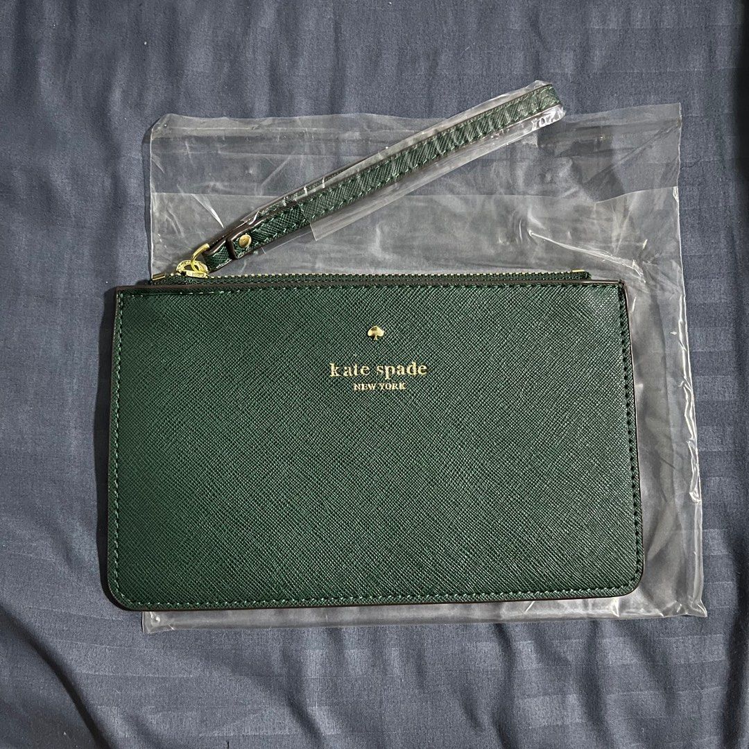 Kate Spade Green Wristlet (Category: Luxury Bags & Wallets) located in Quezon City. Submitted by miles.viii (Listing ID 1412702136, Image 1). Description: - Kate Spade wristlet - Stunning green color - Gold-toned zipper - Includes wrist strap - Brand new, in original packaging - Original price tag: $88.00 - Features the Kate Spade New York logo.