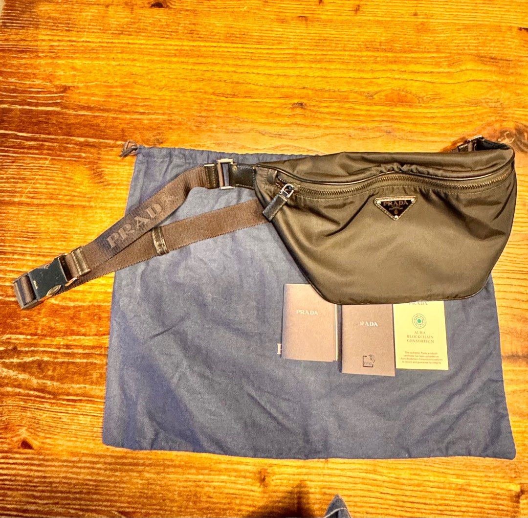 Prada Re-Nylon Waist Bag (Category: Luxury Bags & Wallets) located in Taguig. Submitted by pritsu (Listing ID 1412548901, Image 1). Description: Decluttering personal items. Bought in Amsterdam. PM for more photos. - Authentic Prada Re-Nylon waist bag - Black nylon exterior - Features Prada logo plaque - Adjustable strap - Zip closure - Includes dust bag - Comes with authenticity cards - Blockchain certificate included.