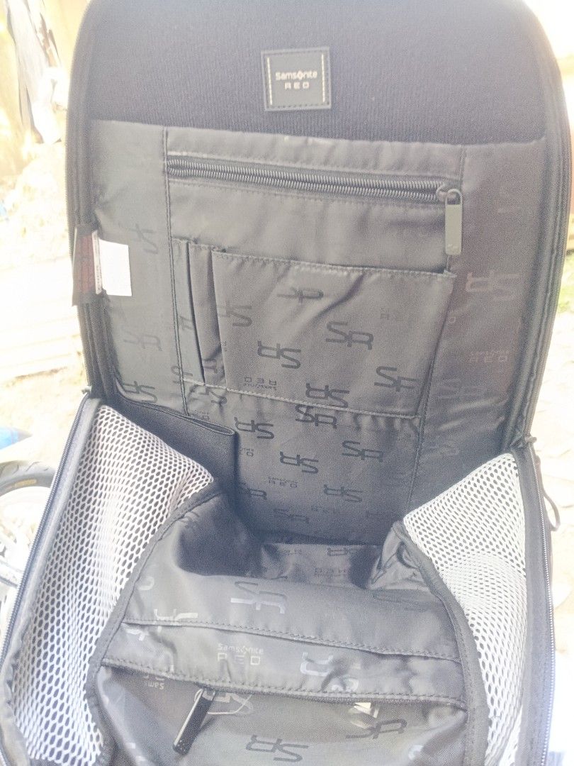 Samsonite RED Backpack (Category: Backpacks) located in Pasig City. Submitted by schizo225 (Listing ID 1412599199, Image 3). Description: Samsonite RED backpack is black and features multiple compartments. It has a smart tag and a 2-year global warranty. The interior includes pockets and the Samsonite RED logo. The backpack has padded shoulder straps and a mesh back panel for comfort. The model number is DF1*09001 cv..