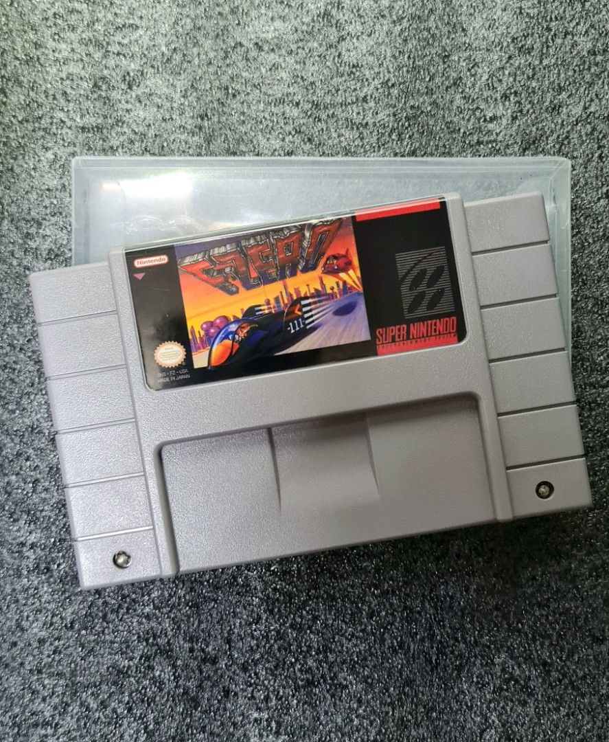 🧧✨️SNES F-ZERO (Category: Nintendo) located in Manila. Submitted by cats_and_dogs_charity (Listing ID 1412661583, Image 1). Description: - F-Zero game cartridge for Super Nintendo (SNES). - Includes game case sleeve - Genre: Racing game..