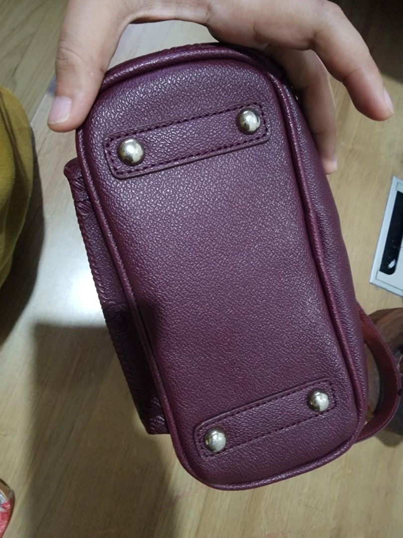 Teenie Weenie Mini Backpack - Burgundy (Category: Backpacks) located in Quezon City. Submitted by zarheign (Listing ID 1412622045, Image 3). Description: Mini backpack features a stylish burgundy color and a compact design. It has a front pocket with a zipper and a main compartment with a patterned lining. The backpack includes adjustable straps and a top handle. Brand hologram in the inside lining. It has a gold-colored logo on the front..