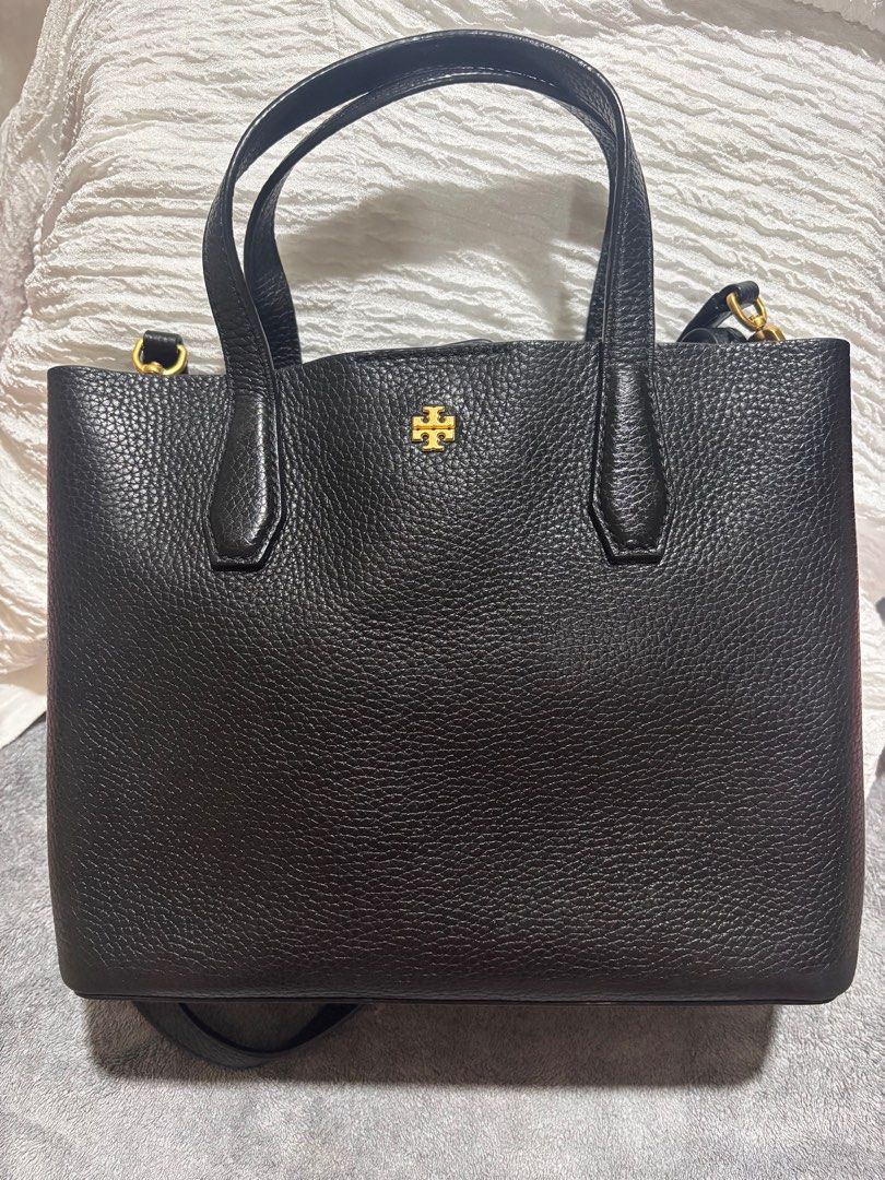 Tory Burch Black Leather Tote Bag (Category: Luxury Bags & Wallets) located in Pasig City. Submitted by melpangga216957 (Listing ID 1412527964, Image 1). Description: - Tory Burch black leather tote bag - Structured design - Top handles and detachable shoulder strap - Gold-tone logo detail - Made of textured leather (saffiano?) - Simple and elegant design - Ideal for everyday use.