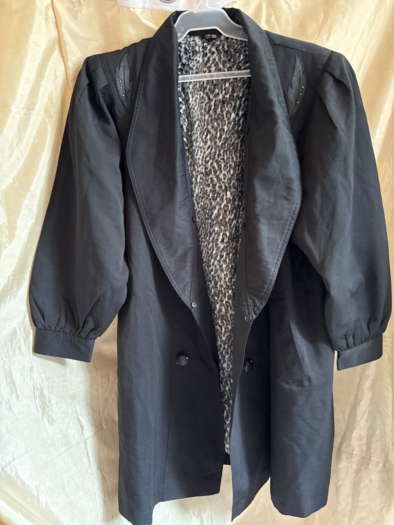 Vintage Black Coat with Leopard Lining (Category: Coats, Jackets and Outerwear) located in Taguig. Submitted by sossypreloved (Listing ID 1412568917, Image 1). Description: - Vintage black coat shoulder 15 Length 33 Armpit to armpit 22 - Leopard print lining - Decorative leaf details on shoulders - Double-breasted style - Long sleeves with buttoned cuffs - Wide collar - Size 11 - Timeless and stylish With stain.