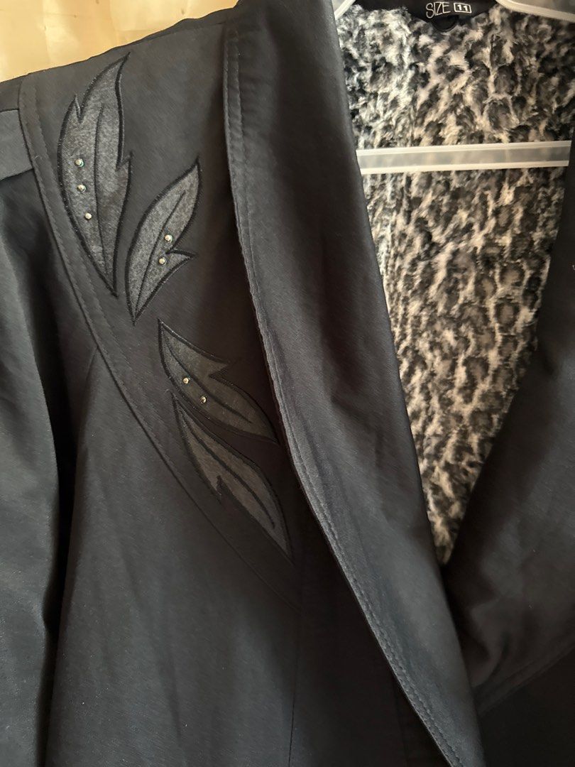Vintage Black Coat with Leopard Lining (Category: Coats, Jackets and Outerwear) located in Taguig. Submitted by sossypreloved (Listing ID 1412568917, Image 3). Description: - Vintage black coat shoulder 15 Length 33 Armpit to armpit 22 - Leopard print lining - Decorative leaf details on shoulders - Double-breasted style - Long sleeves with buttoned cuffs - Wide collar - Size 11 - Timeless and stylish With stain.
