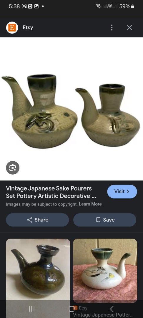 Vintage Japanese Sake Pourers (Category: Dinnerware & Cutlery) located in Manila. Submitted by padillahe35291 (Listing ID 1412621607, Image 3). Description: Set of two vintage Japanese sake pourers. They have a unique design with a spout and a wide opening. The pourers feature a decorative floral design. The color is a mix of beige and green. These pourers are perfect for serving sake in style..