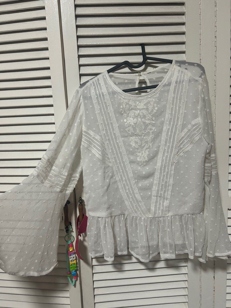 White Embroidered Bell Sleeve Blouse (Category: Blouses) located in Manila. Submitted by treenitea (Listing ID 1412621168, Image 1). Description: - White embroidered blouse - Round neckline - Keyhole back closure - Bell sleeves - Ruffled hem - Subtle polka dot pattern - Perfect for a chic, feminine look -Zara cut out tag.