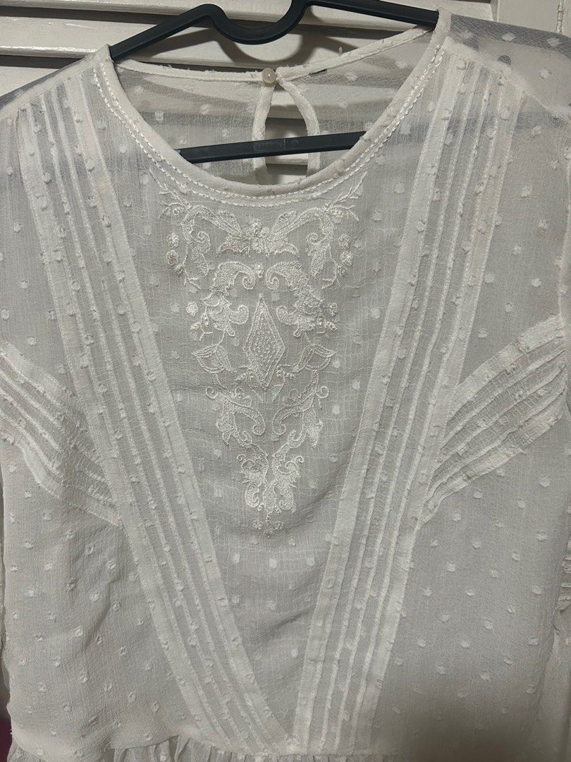 White Embroidered Bell Sleeve Blouse (Category: Blouses) located in Manila. Submitted by treenitea (Listing ID 1412621168, Image 2). Description: - White embroidered blouse - Round neckline - Keyhole back closure - Bell sleeves - Ruffled hem - Subtle polka dot pattern - Perfect for a chic, feminine look -Zara cut out tag.