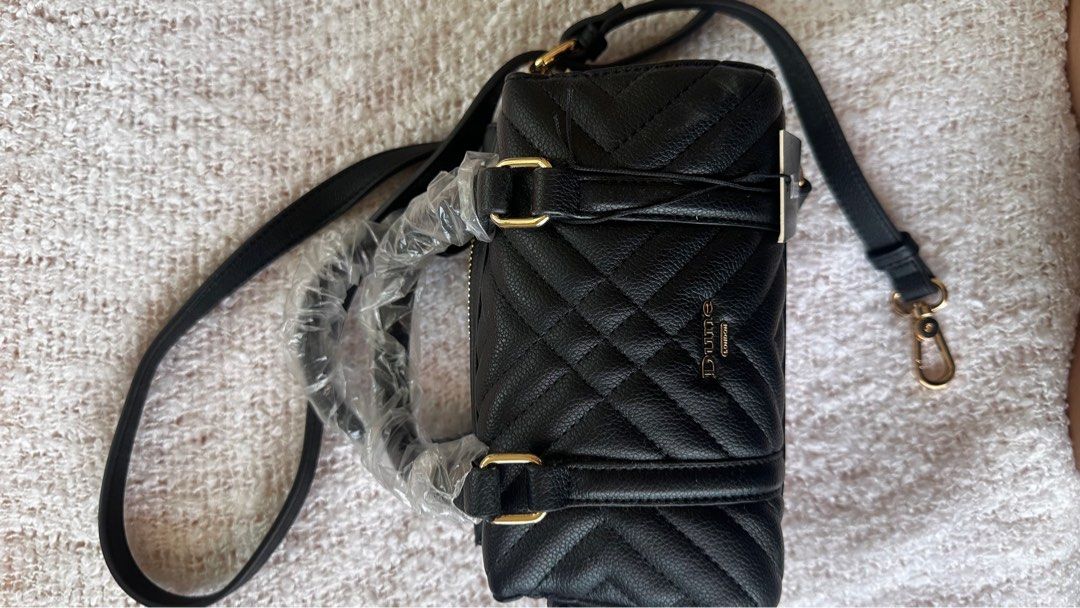Dune London Black Quilted Handbag (Category: Cross-body Bags) located in Quezon City. Submitted by arvela (Listing ID 1412726013, Image 3). Description: - Dune London handbag - Black, quilted design - Small size - Top handles and detachable shoulder strap - Gold-tone hardware - Zip closure - Includes original tag.
