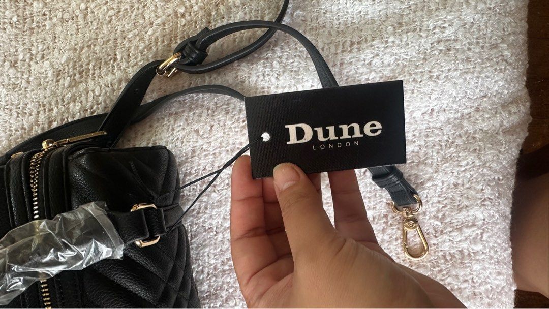 Dune London Black Quilted Handbag (Category: Cross-body Bags) located in Quezon City. Submitted by arvela (Listing ID 1412726013, Image 2). Description: - Dune London handbag - Black, quilted design - Small size - Top handles and detachable shoulder strap - Gold-tone hardware - Zip closure - Includes original tag.