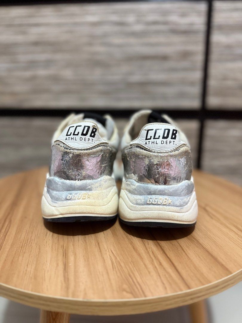 Golden Goose Running Sole Sneakers (Category: Sneakers) located in Las Pinas. Submitted by bujetbujit (Listing ID 1412853927, Image 3). Description: - Golden Goose Running Sole sneakers - Silver and white colorway - Iconic star logo on the side - Distressed design for a vintage look - Black soles with GGDB logo - "CCDB ATHL DEPT." text on the back - "RUNNING" printed on the insoles.