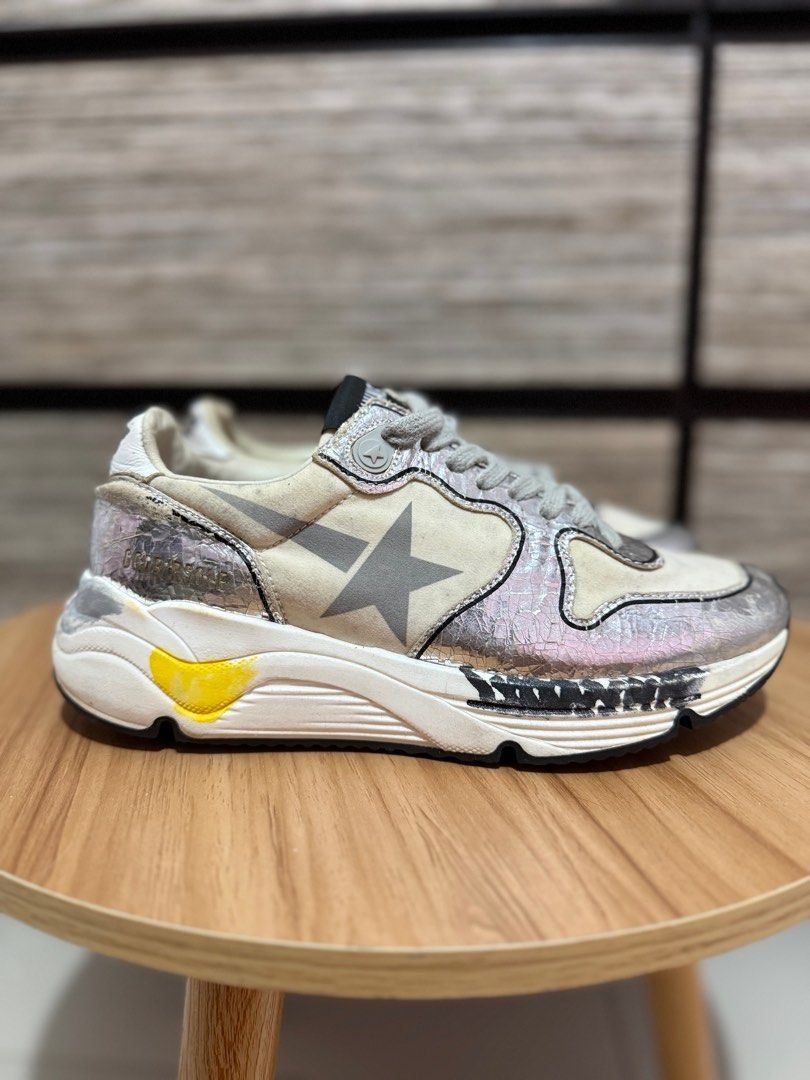 Golden Goose Running Sole Sneakers (Category: Sneakers) located in Las Pinas. Submitted by bujetbujit (Listing ID 1412853927, Image 2). Description: - Golden Goose Running Sole sneakers - Silver and white colorway - Iconic star logo on the side - Distressed design for a vintage look - Black soles with GGDB logo - "CCDB ATHL DEPT." text on the back - "RUNNING" printed on the insoles.
