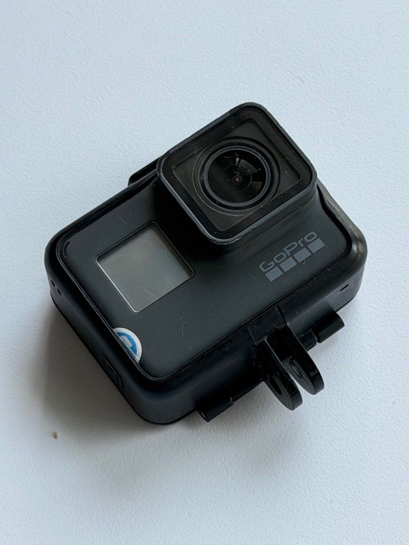 GoPro Hero 5 (Category: Cameras) located in Taguig. Submitted by dreamstudios (Listing ID 1412712988, Image 1). Description: - Black GoPro action camera - Features a lens and small screen - Includes the GoPro logo - Comes with a mounting bracket - Rubber coating slightly damaged.