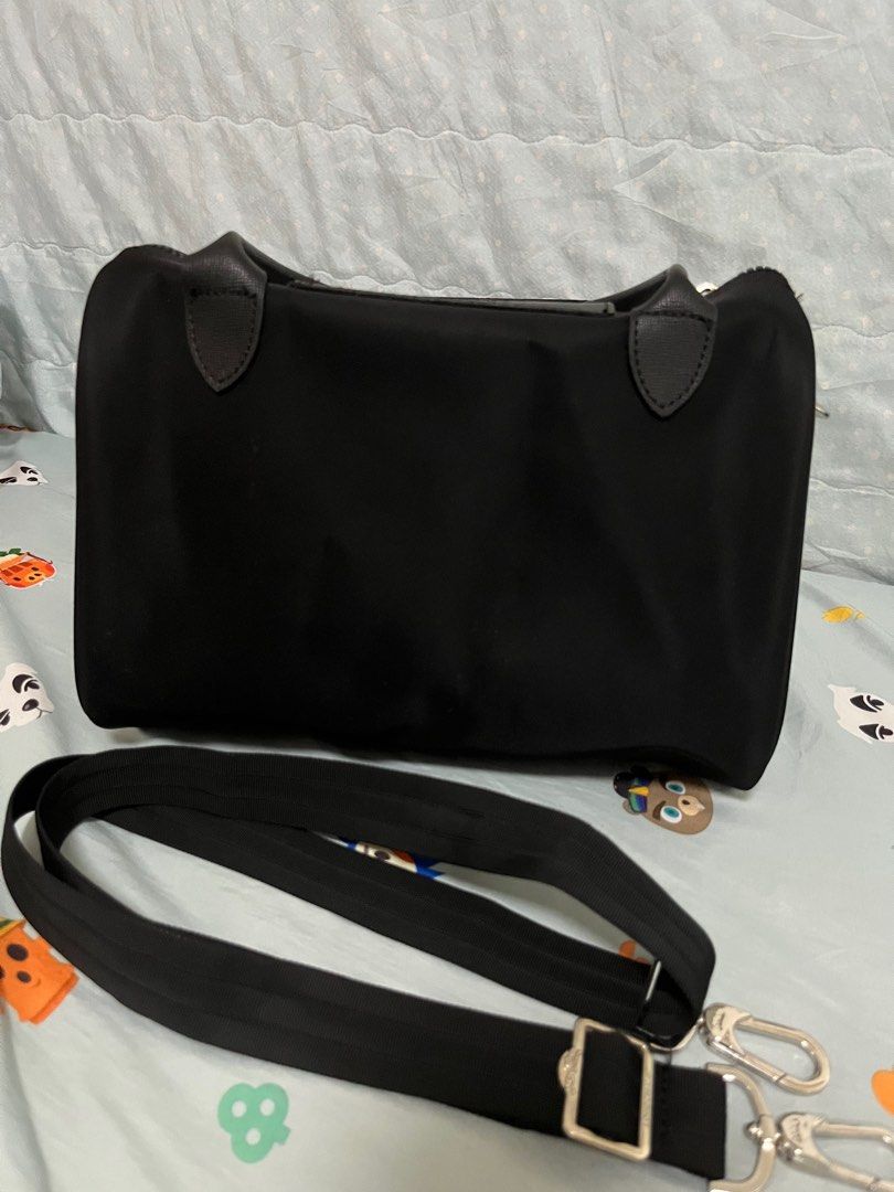 Longchamp Handbag / Doctors Bag (Category: Luxury Bags & Wallets) located in Angeles City. Submitted by pheeebees (Listing ID 1412760390, Image 2). Description: Black Longchamp Le Pliage Cuir handbag with a detachable shoulder strap. Features a top handle and a flap closure. The bag has a zipper closure and silver-tone hardware. Made in France. The bag shows some signs of wear, including some white spots on the exterior. - has white spots due to 