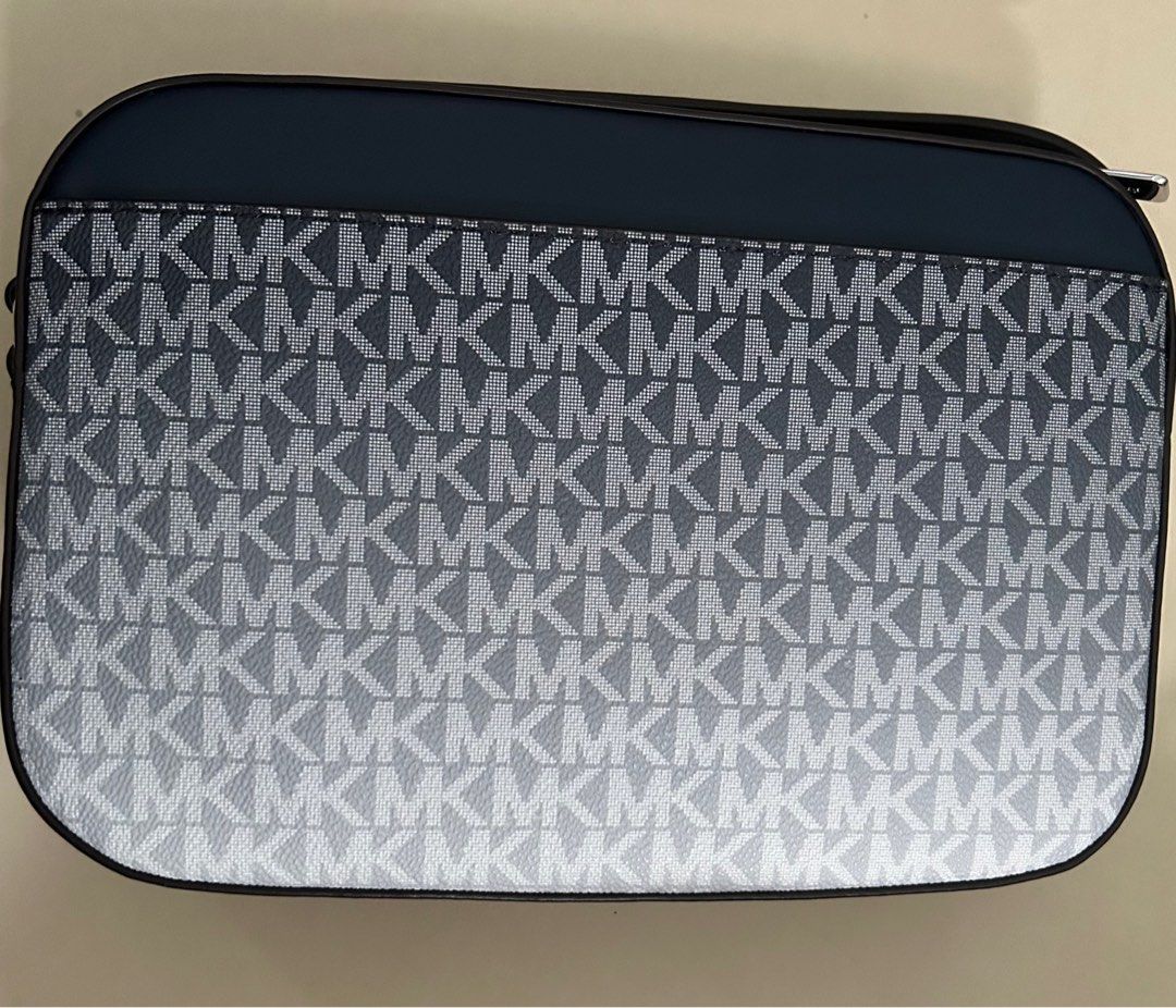 Michael Kors Jet Set Crossbody Bag (Category: Cross-body Bags) located in Pasig City. Submitted by jrrhs (Listing ID 1412777590, Image 3). Description: - Michael Kors Jet Set Item crossbody bag - Navy color - Silver chain strap - Zipper closure - MK logo pattern - MSRP: $258.00.