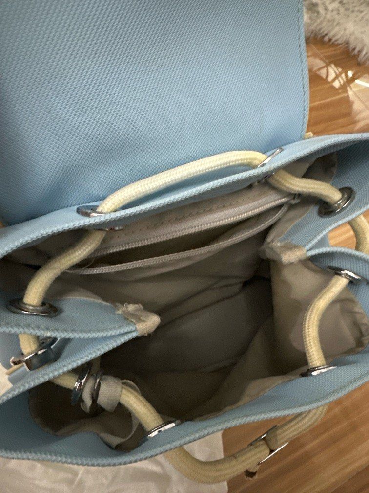 Original Lacoste Small Backpack (Sky Blue) (Category: Luxury Bags & Wallets) located in Manila. Submitted by getreadyandeclutter (Listing ID 1412828007, Image 2). Description: - Original Lacoste Backpack - Color: Sky Blue - Well taken care of, In good condition, needs cleaning only‼️ - Price negotiable to ₱3.5k - Adjustable Strap .