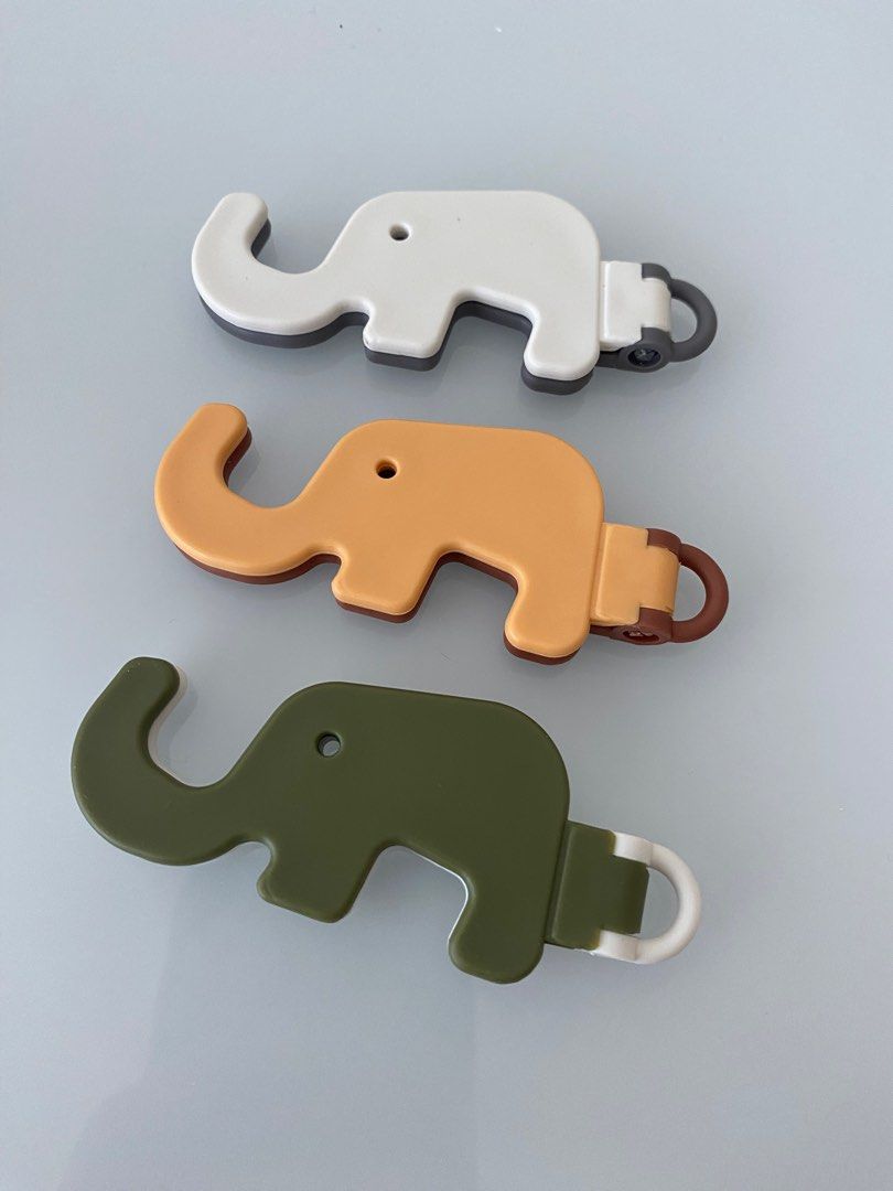 Phone or photo stand (Category: Mounts & Holders) located in Mandaluyong City. Submitted by preLAVed (Listing ID 1412715171, Image 2). Description: - Adorable elephant-shaped phone or photo stand. -take all available in three colors: white, mustard yellow, and olive green. - Cute and functional design. - In excellent condition..