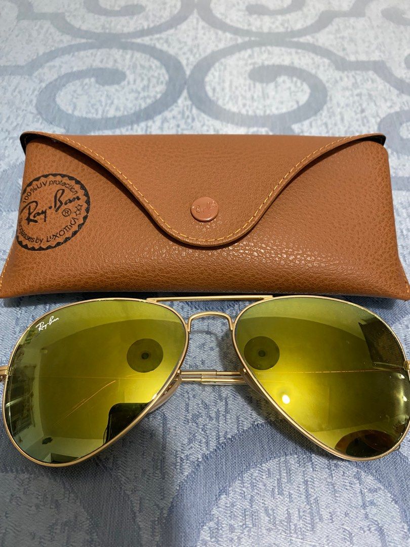 Ray-Ban Aviator Sunglasses (Category: Sunglasses & Eyewear) located in Cagayan de Oro. Submitted by cu_2022 (Listing ID 1412855933, Image 1). Description: Authentic Ray-Ban Aviator sunglasses with a gold frame and yellow-tinted lenses. Includes the original brown leather case. The Ray-Ban logo is visible on the lens and the case. A classic and stylish accessory..