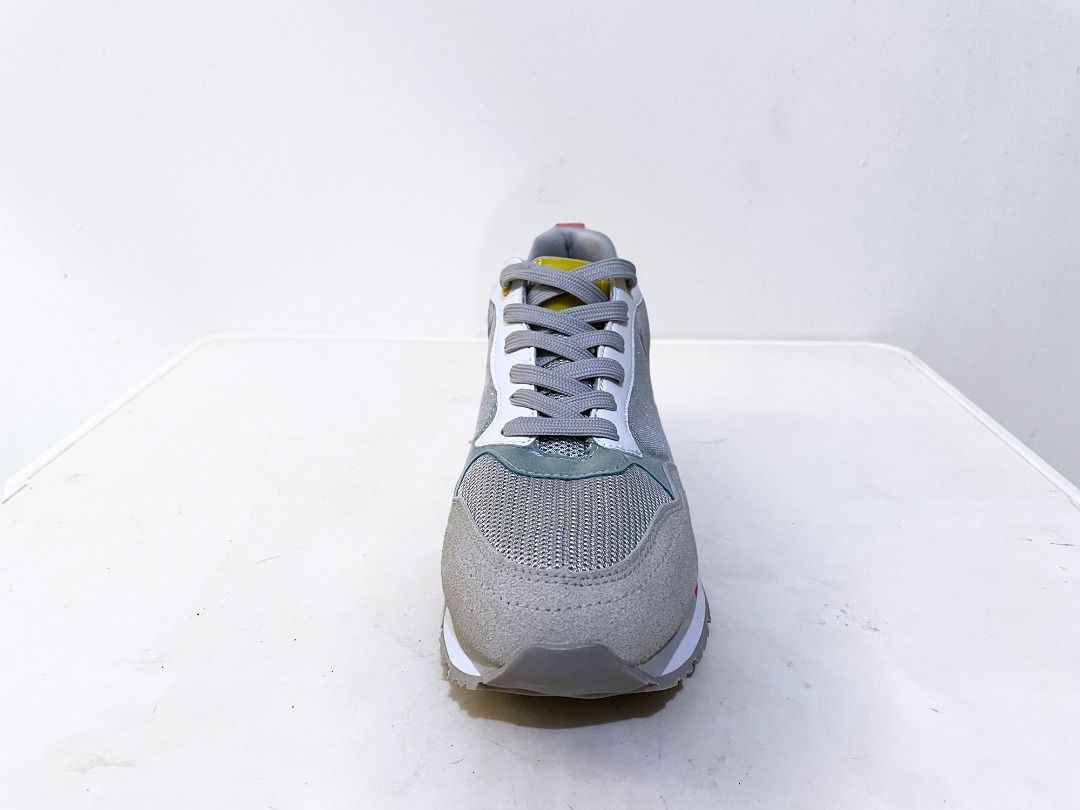 Versatile Classic Gray Trainers Women's 8 (Category: Sneakers) located in Manila. Submitted by thejnyblock (Listing ID 1412852027, Image 2). Description: Stylish gray sneakers with a versatile design. Features a mix of materials including mesh and suede. The sole is white with a gray tread. The interior tag indicates a size 8 for women. The sneakers have a red accent on the sole and a pop of yellow on the heel. Perfect for everyday wear, vibing, 