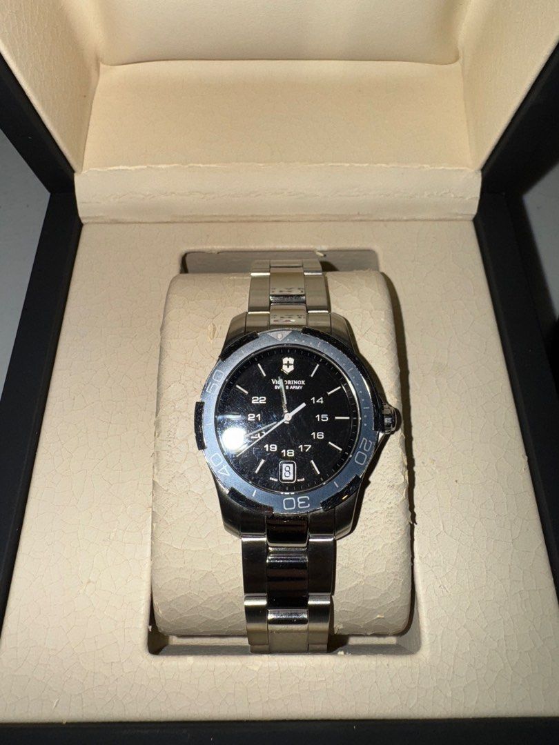 Victorinox Swiss Watch (Category: Women's Watches) located in Quezon City. Submitted by digitalthrifting (Listing ID 1412840315, Image 2). Description: - Victorinox Swiss Army watch - Black dial - Stainless steel bracelet - Includes original box and instruction manual - Extra link included - Date display - Rotating bezel.