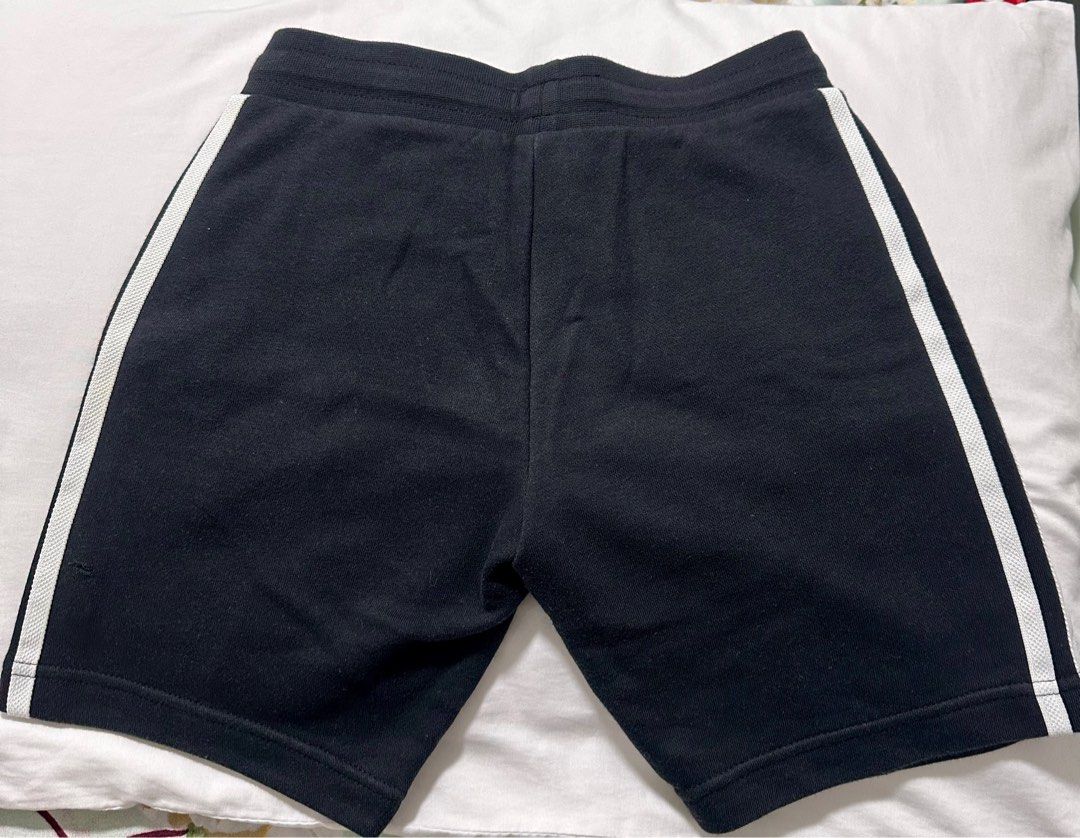 Adidas Kids Shorts (Category: Babies & Kids Fashion) located in Las Pinas. Submitted by tomarigato (Listing ID 1407760687, Image 3). Description: - Adidas kids shorts - Color: Black with white stripes - Adidas logo on front - Drawstring waistband - Size: 130 (fits 7-8 years old) RFS: Outgrown take note: photo 3 - small hole at the back below left side.