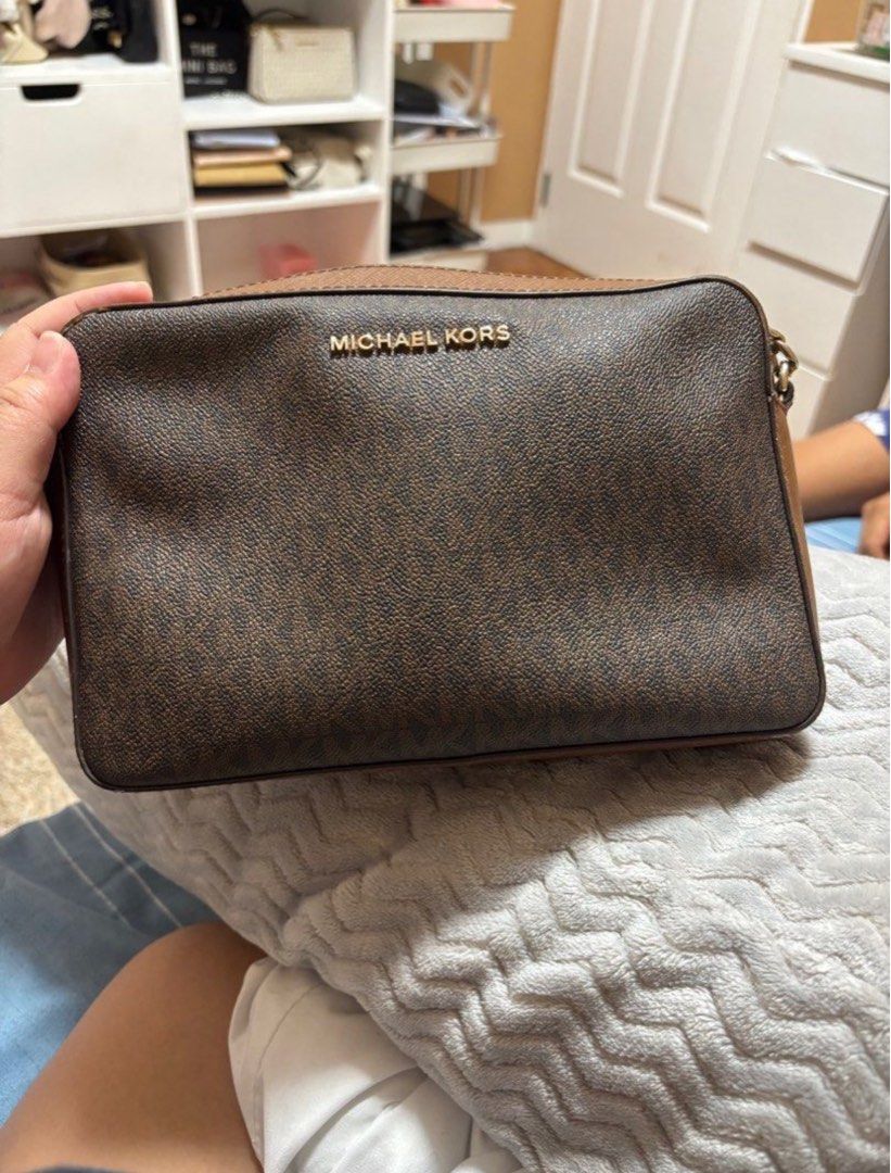 Authentic Michael Kors Crossbody Camera Bag (Category: Luxury Bags & Wallets) located in Marikina City. Submitted by fairy_mary (Listing ID 1407928863, Image 1). Description: - Michael Kors crossbody camera bag - Brown monogram pattern - Gold chain strap - Brown leather strap - Zip closure - Gold Michael Kors logo.