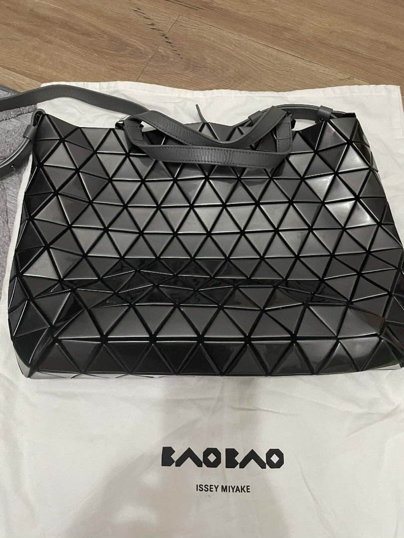 Bao Bao Issey Miyake Authentic Tote Bag (Category: Luxury Bags & Wallets) located in Manila. Submitted by sterling_grace (Listing ID 1407767266, Image 1). Description: Stylish Bao Bao Issey Miyake tote bag. Features a geometric design in a dark grey color. Includes a top handle and a shoulder strap. The interior has a zipper closure. Comes with a dust bag. Perfect for everyday use or special occasions..